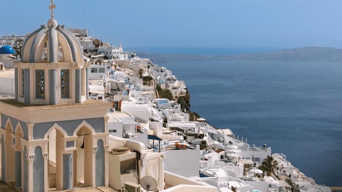 Imerovigli village in Santorini with church and panoramic caldera view.